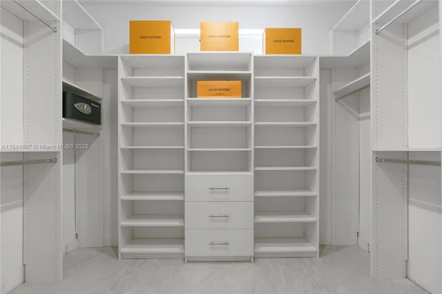 a view of walk in closet with empty racks