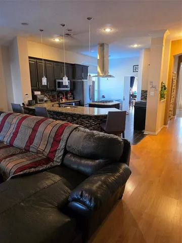 a living room with furniture and kitchen view