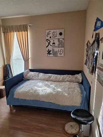 a bedroom with a bed and a chair