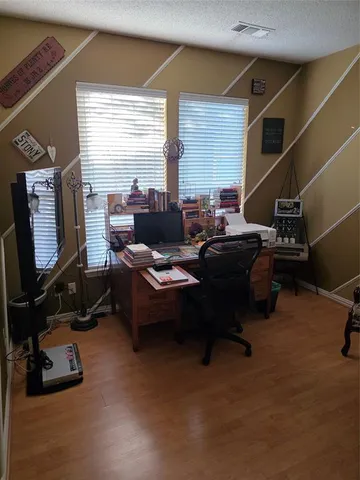 a living room with furniture gym equipment and a large window