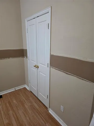 an empty room with wooden floor