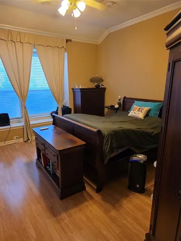 a living room with a bed furniture and a wooden floor