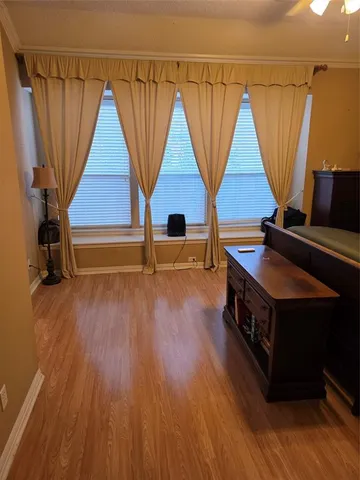 a room with wooden floors and pool table