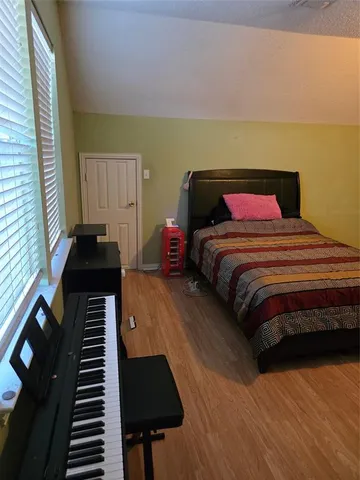 a bedroom with a bed and a potted plant