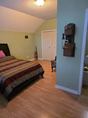 a bedroom with a bed and cabinets