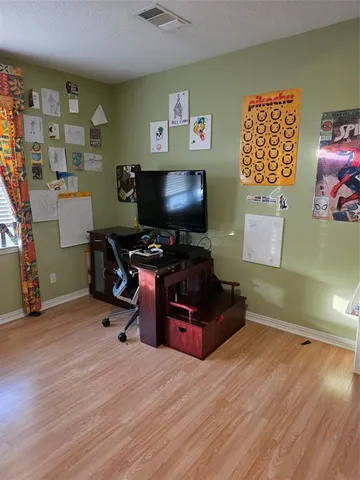 a bedroom with furniture and a flat screen tv
