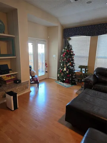 a living room with furniture gym equipment and a window