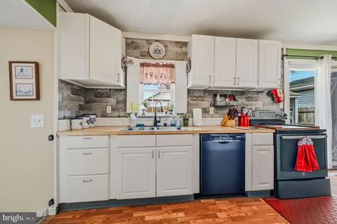 a kitchen with stainless steel appliances granite countertop a stove and cabinets