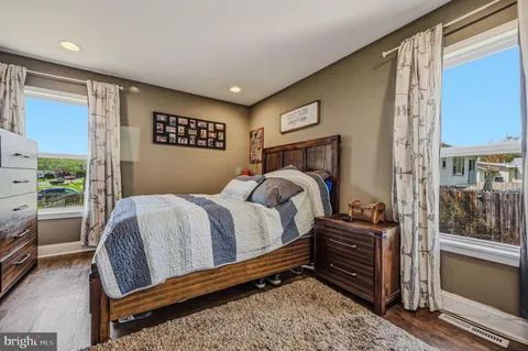 a bedroom with a bed dresser and a window