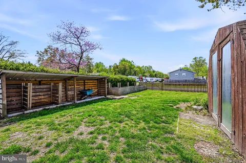 a view of a backyard with wooden fence