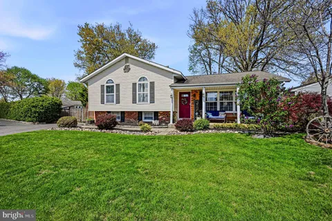 a view of a house with a yard and deck