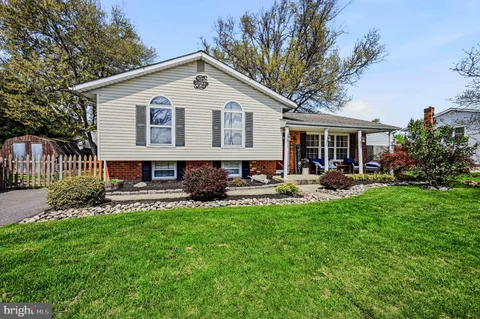 a view of a house with a yard patio and swimming pool
