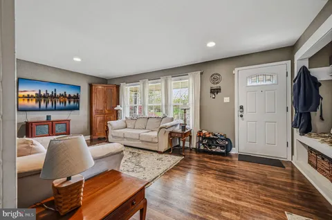 a living room with furniture a rug and a flat screen tv