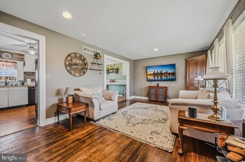 a living room with furniture and wooden floor