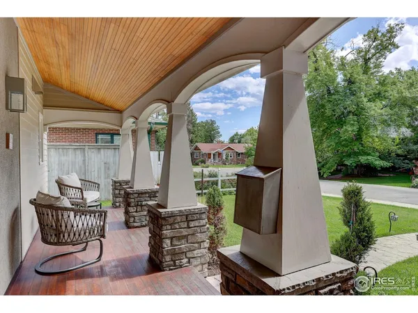 a view of a porch with furniture and garden