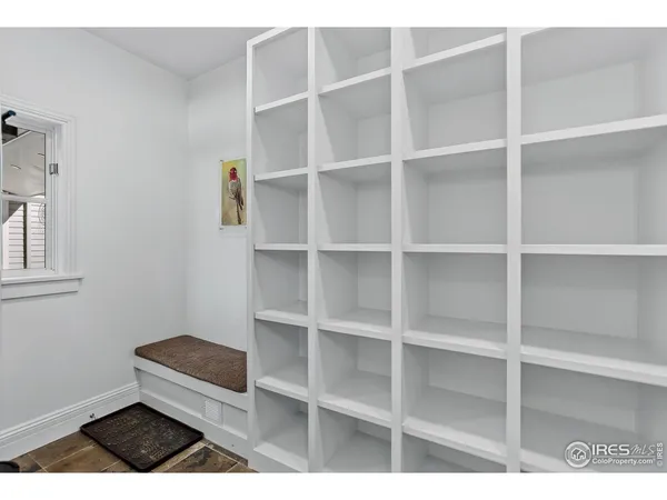 a living room with a bed and a window