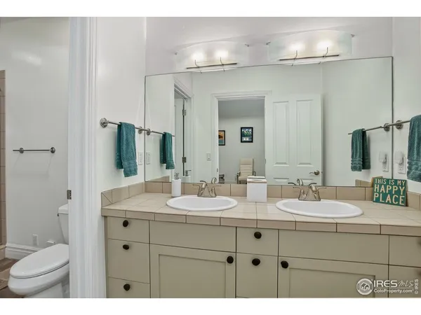 a bathroom with a sink double vanity and a mirror