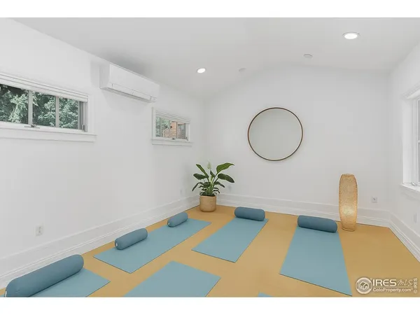 a living room with a couch and a potted plant