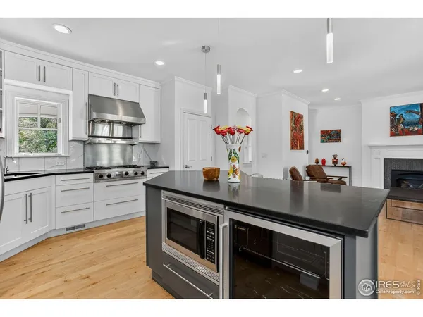 a kitchen with stainless steel appliances kitchen island granite countertop a stove a sink and a refrigerator
