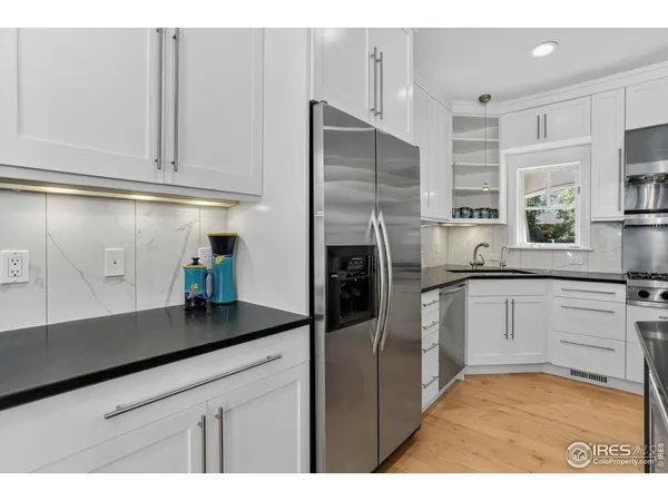 a kitchen with stainless steel appliances granite countertop a refrigerator and a sink