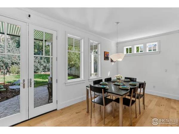 a dining room with furniture and wooden floor