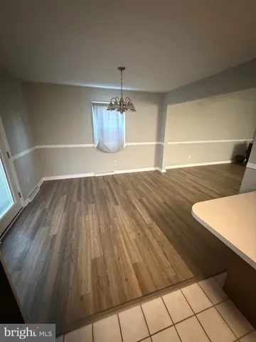 a view of a living room and wooden floor
