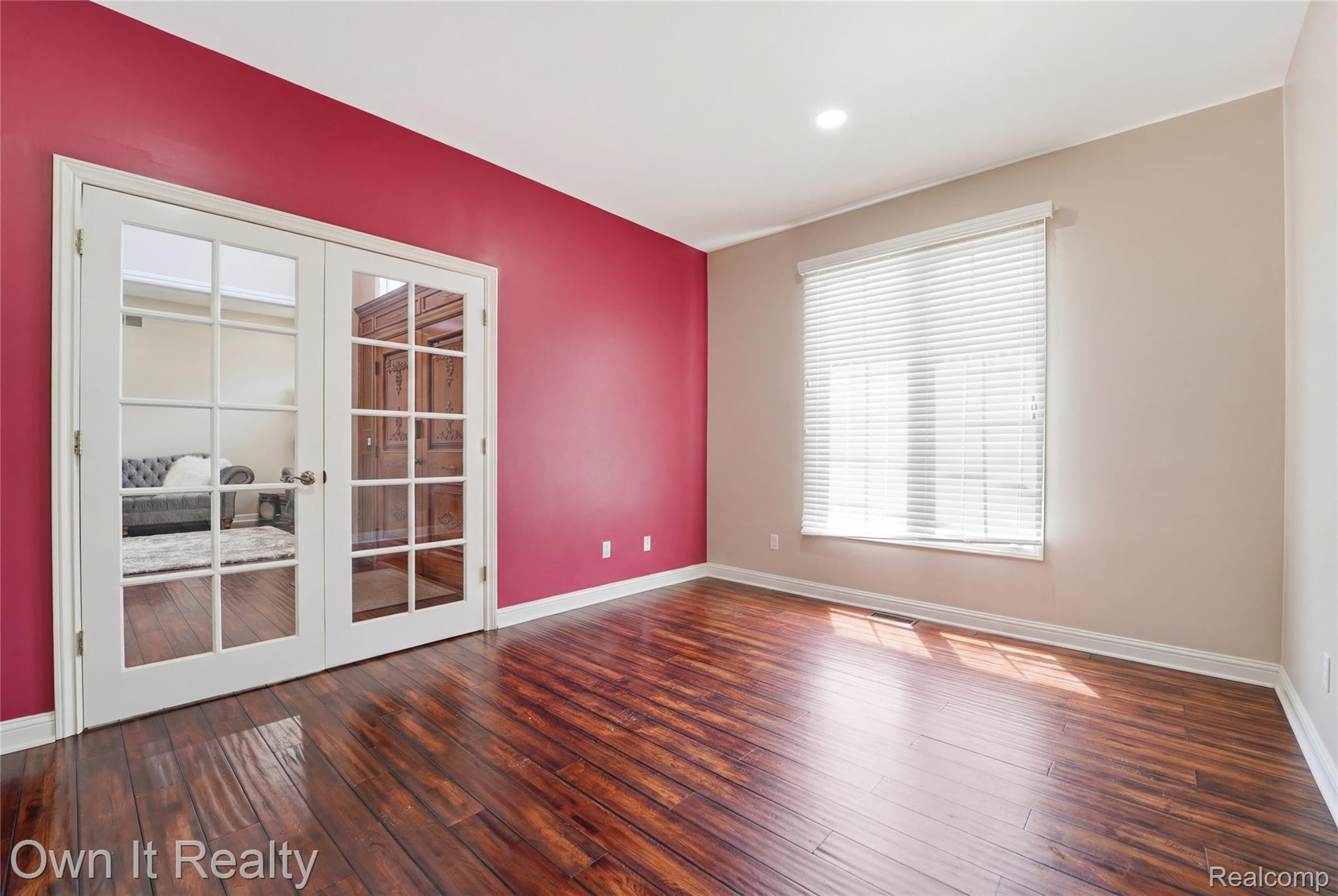 48280 Gladstone Road Canton, MI 48188 - Photo 26 of 59 Room featuring rich wood-finish flooring, white baseboards, a large window with blinds, and recessed lighting