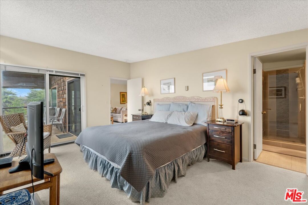 67 Pelican Point Watsonville, CA 95076 - Photo 14 of 25 a bedroom with a bed and a chandelier