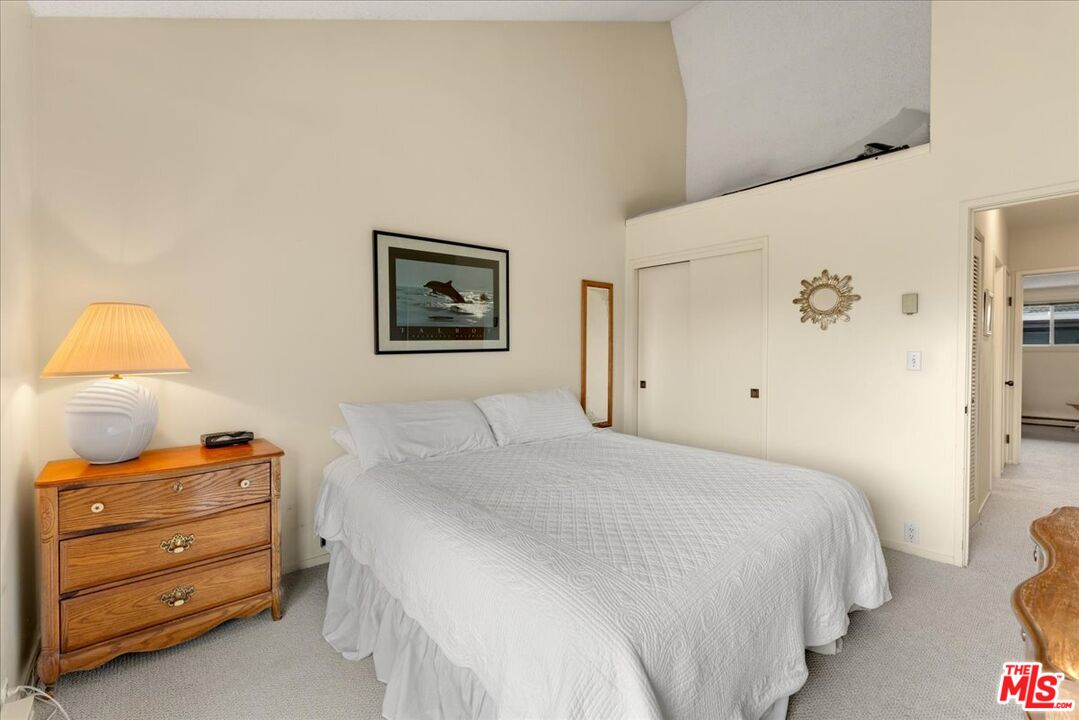 67 Pelican Point Watsonville, CA 95076 - Photo 18 of 25 a bedroom with a bed and a lamp on dresser