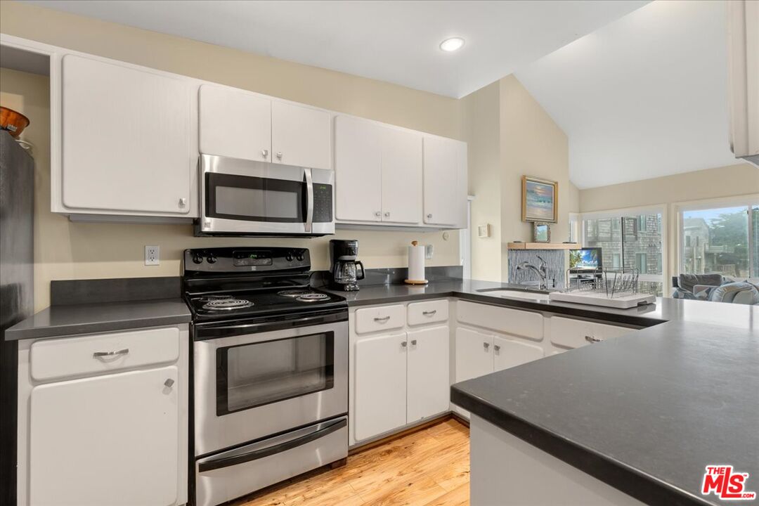 67 Pelican Point Watsonville, CA 95076 - Photo 4 of 25 a kitchen with stainless steel appliances granite countertop a stove a sink and a microwave