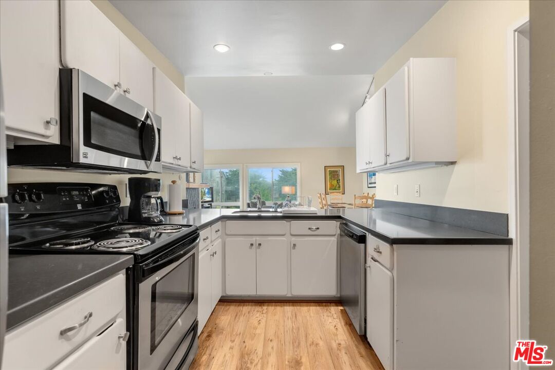 67 Pelican Point Watsonville, CA 95076 - Photo 5 of 25 a kitchen with stainless steel appliances granite countertop a sink and stove top oven