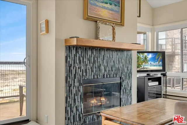 a living room with furniture a large window and a potted plant
