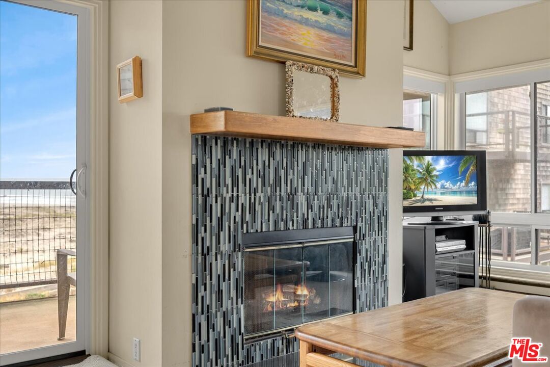 67 Pelican Point Watsonville, CA 95076 - Photo 7 of 25 a living room with fireplace furniture and a flat screen tv