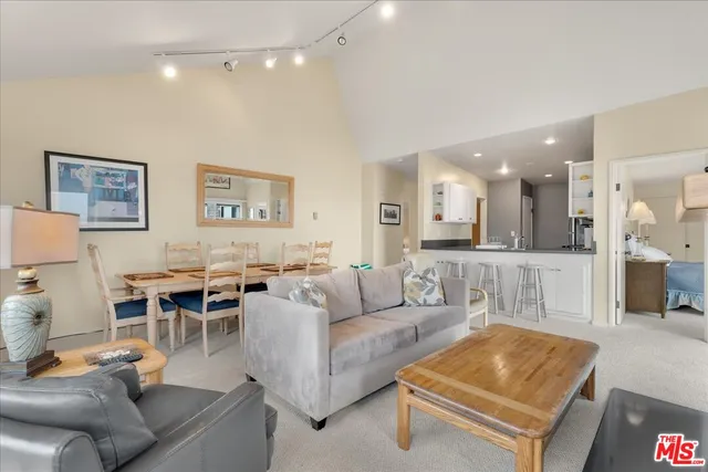 a kitchen with stainless steel appliances kitchen island granite countertop a refrigerator and cabinets