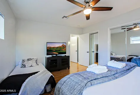 a bedroom with a bed and a chandelier