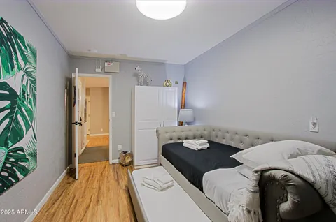 a bed room with two beds and a potted plant