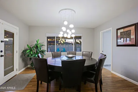 a view of a dining room with furniture and chandelier