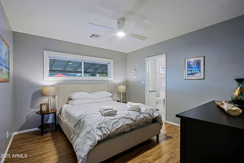a bedroom with a bed and wooden floor