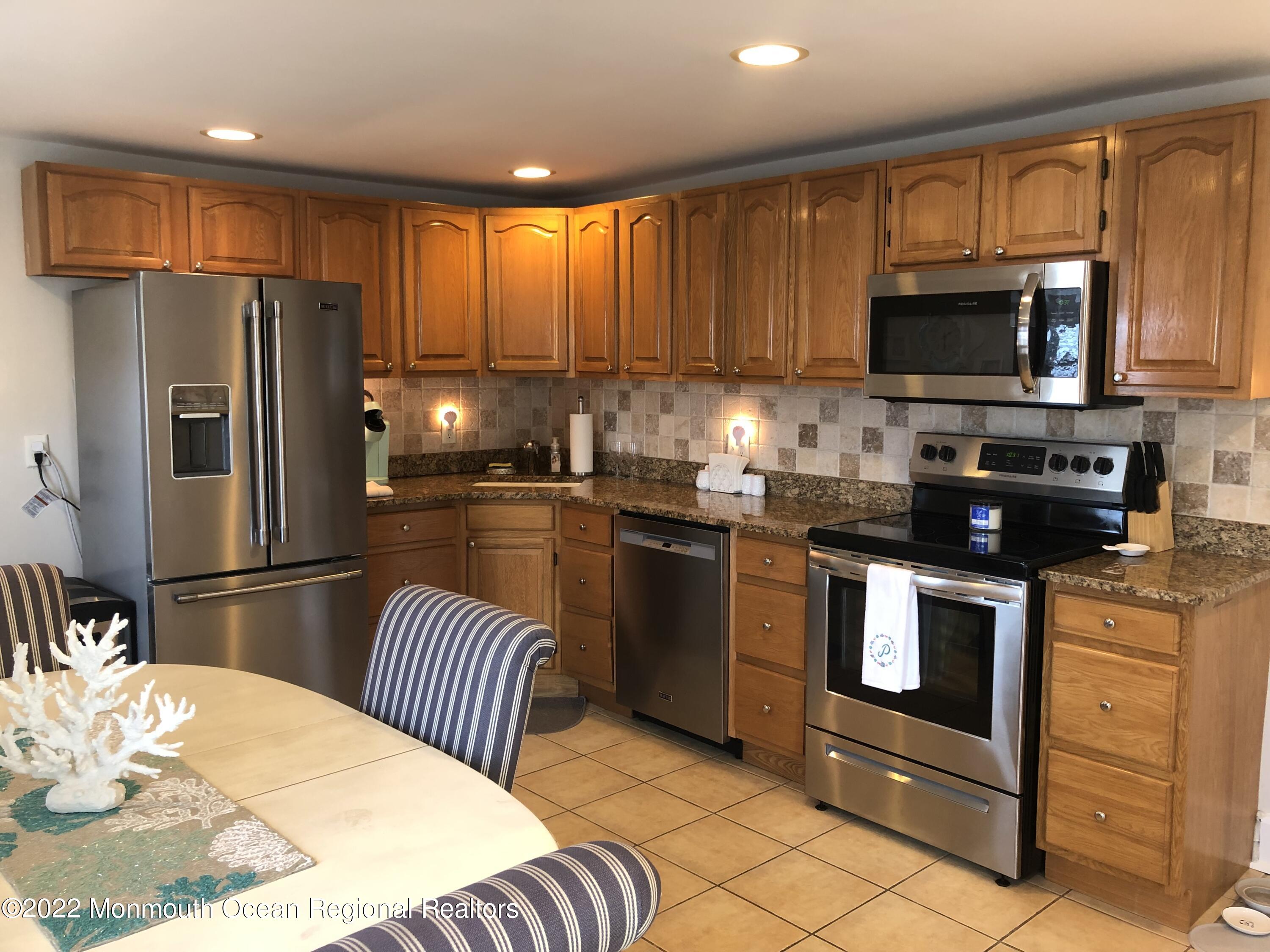 1717 River Road Belmar, NJ 07719 - Photo 15 of 25 a kitchen with stainless steel appliances a stove refrigerator sink and microwave