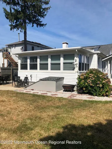 a front view of a house with yard and seating space