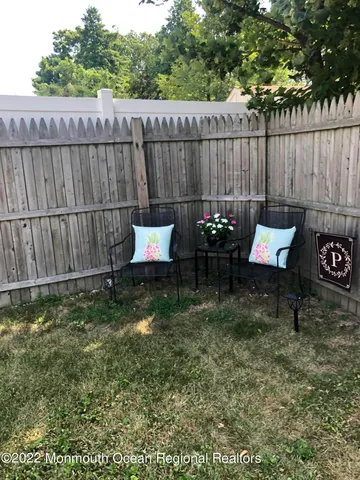 a backyard of a house with table and chairs
