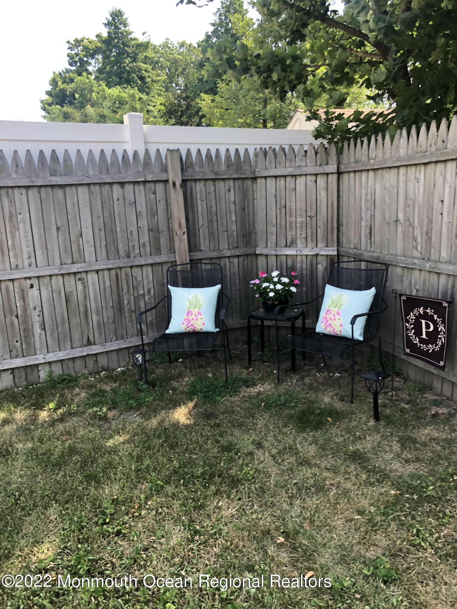1717 River Road Belmar, NJ 07719 - Photo 22 of 25 a backyard of a house with table and chairs