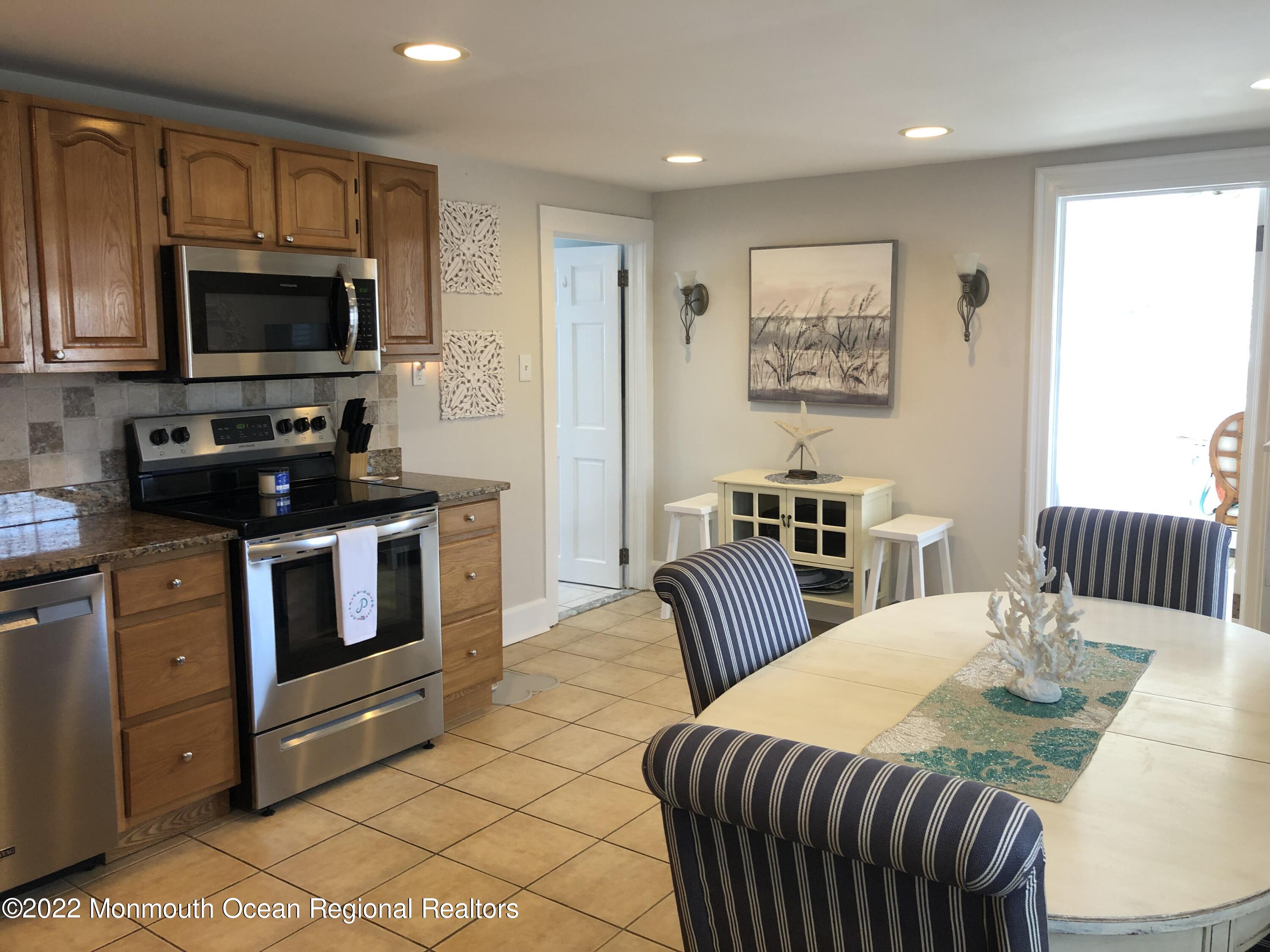 1717 River Road Belmar, NJ 07719 - Photo 4 of 25 a kitchen with stainless steel appliances kitchen island granite countertop a sink and a microwave