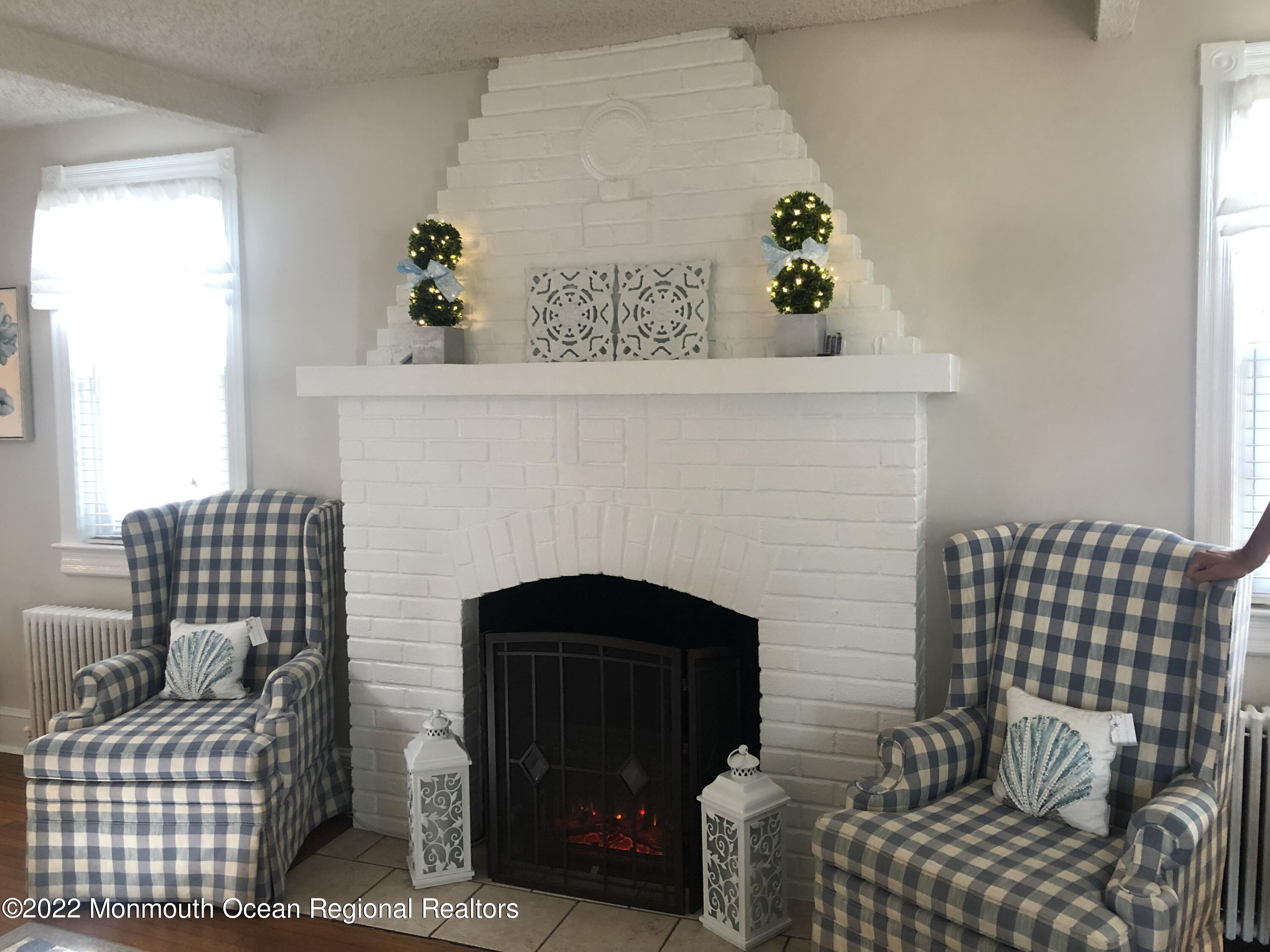 1717 River Road Belmar, NJ 07719 - Photo 6 of 25 a living room with furniture and a fireplace