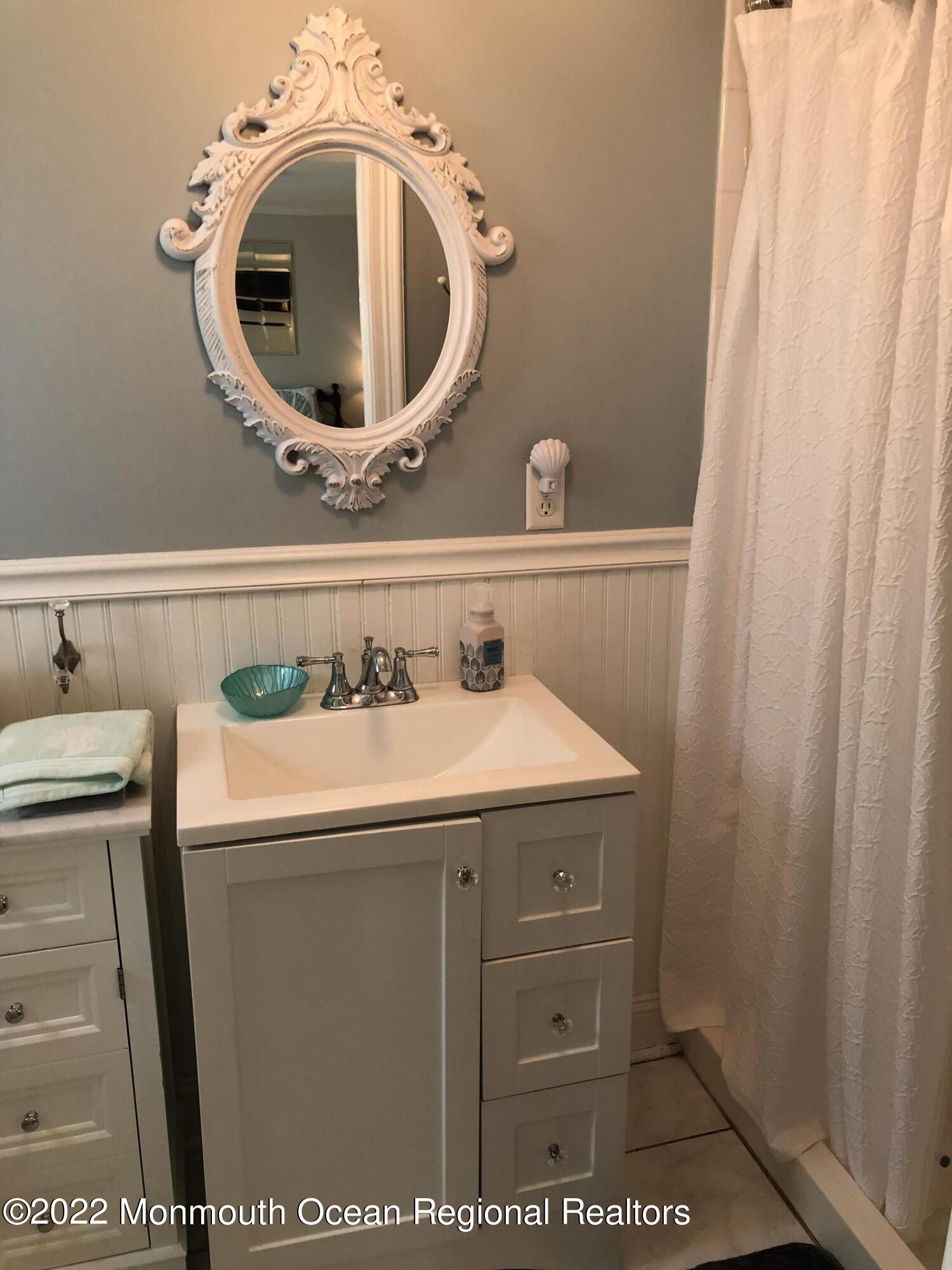 1717 River Road Belmar, NJ 07719 - Photo 8 of 25 a bathroom with a sink and a mirror