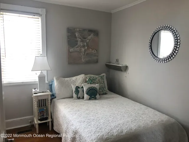 a bedroom with a bed and a mirror