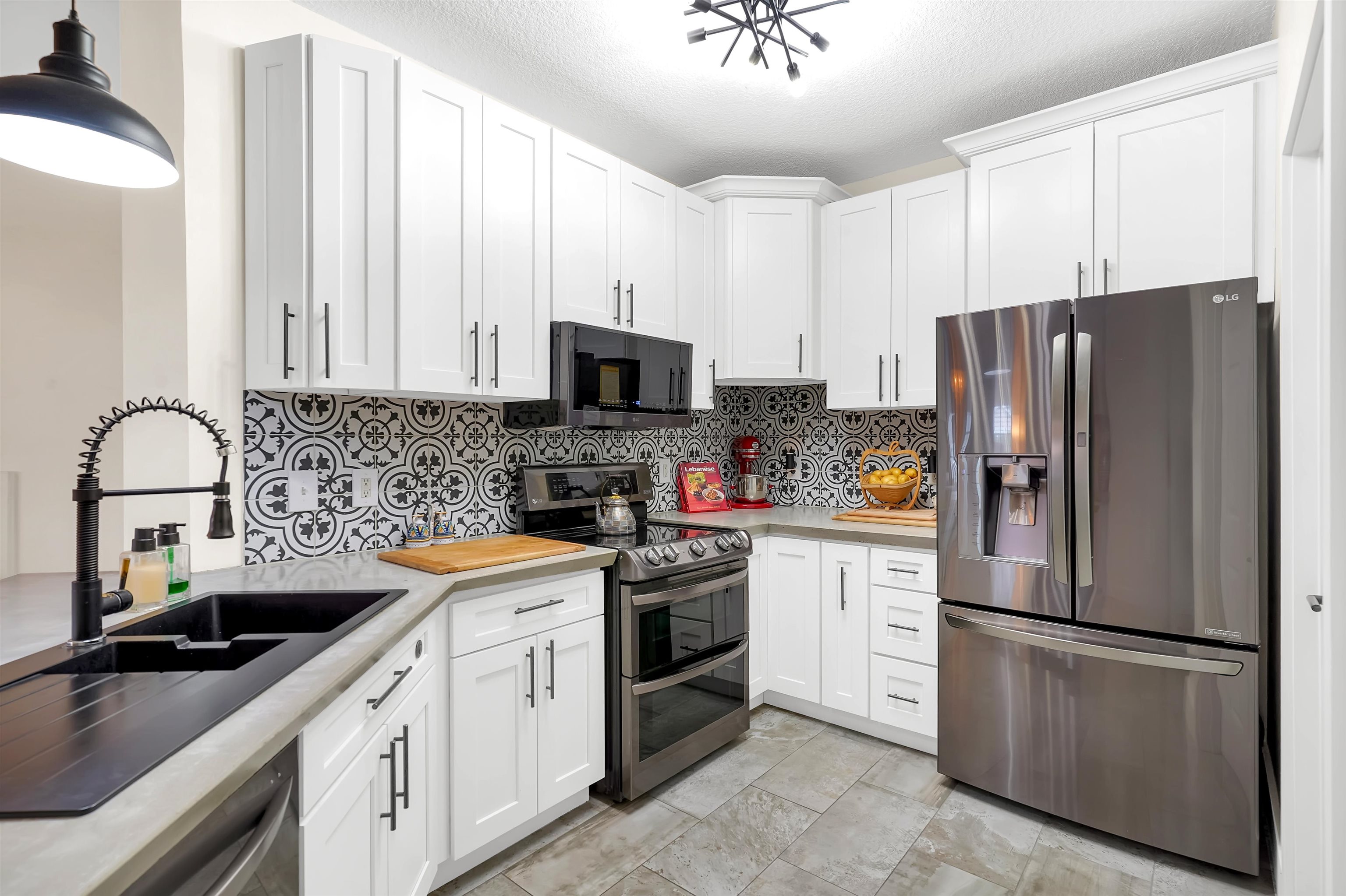4629 Serena Circle St. Augustine, FL 32084 - Photo 11 of 47 a kitchen with stainless steel appliances white cabinets a sink and a stove