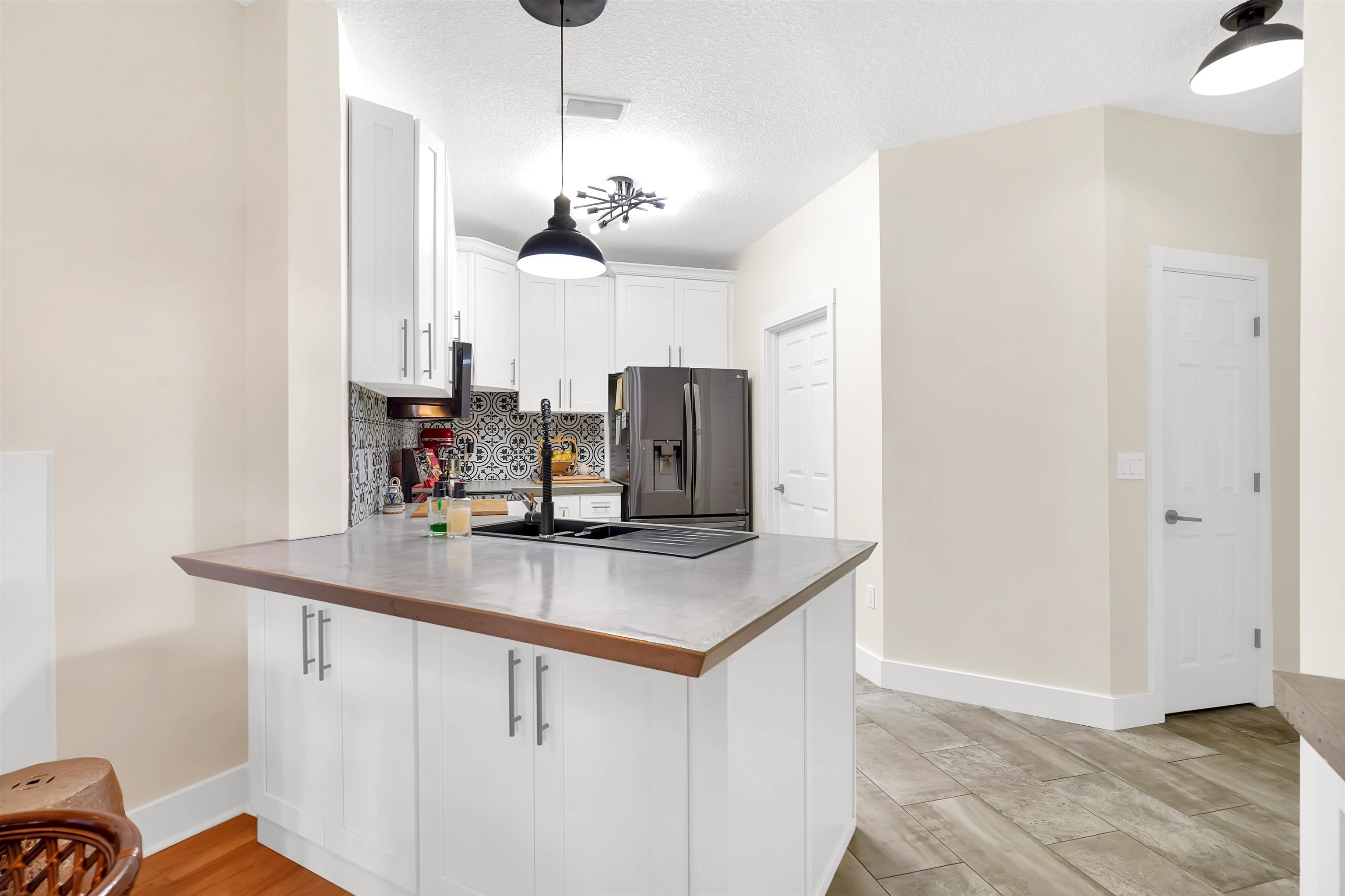 4629 Serena Circle St. Augustine, FL 32084 - Photo 13 of 47 a kitchen with stainless steel appliances granite countertop cabinets and chandelier