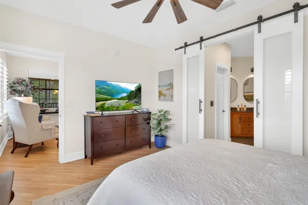 a bedroom with a bed and a flat screen tv