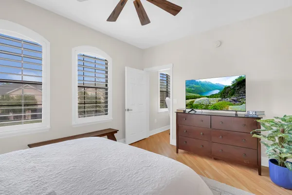 a bedroom with a bed and a window